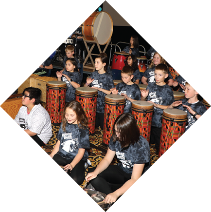 Students in a group playing bongos together.